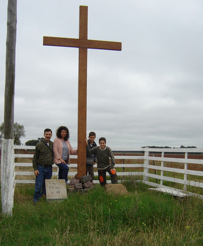 "Cross of the Request" with Gerardo Waimann, his wife and children. In the past, each November, the women of the colony walked to this site to pray for a good harvest. Photograph courtesy of Gerardo Waimann.