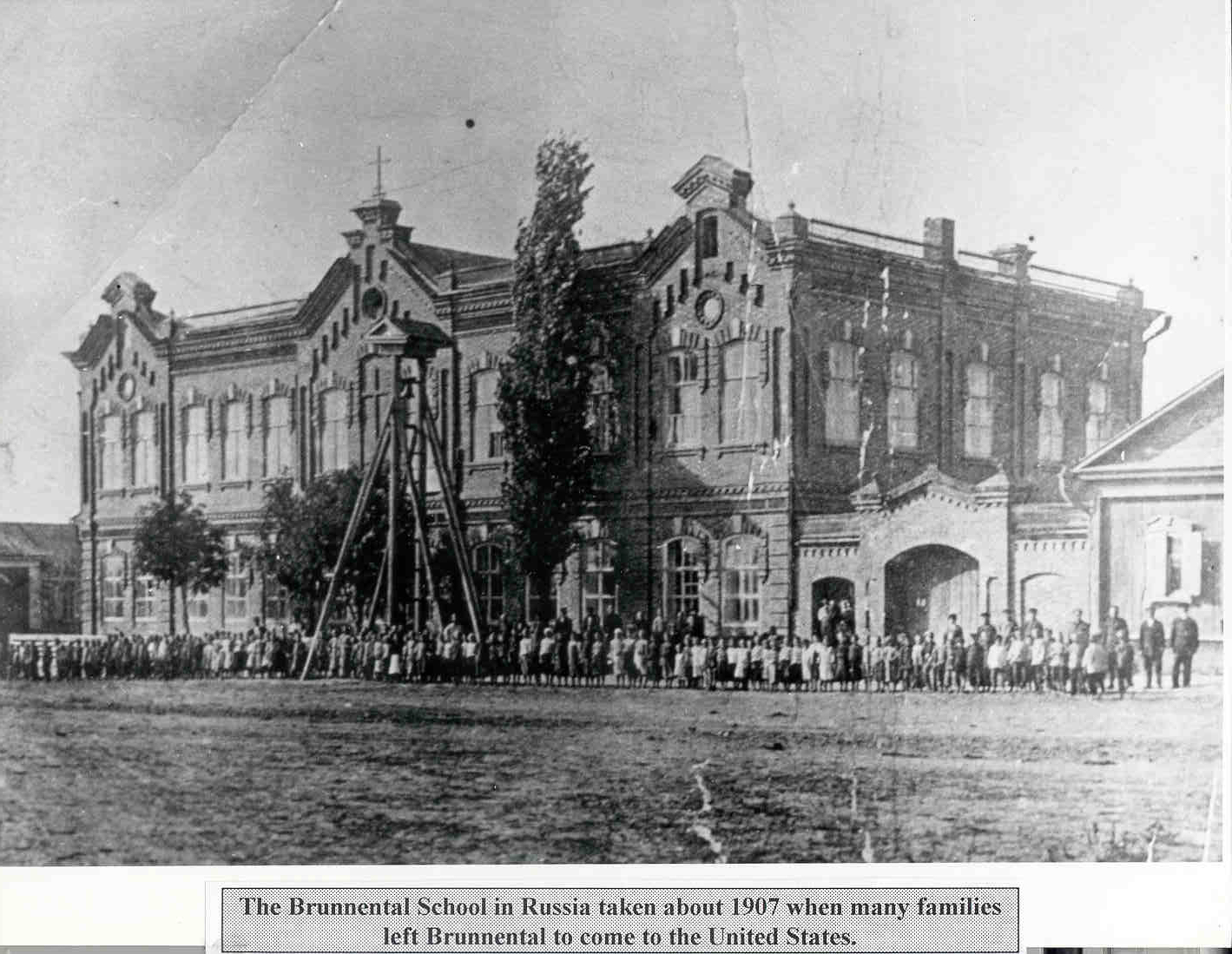 According to Mrs. Becker and Marie (Greenwald) Bandey, this photograph was taken in 1907 in front of the Brunnental School when a large number of Brunnentaler's were leaving for the USA. It was a "farewell photo" for these families.